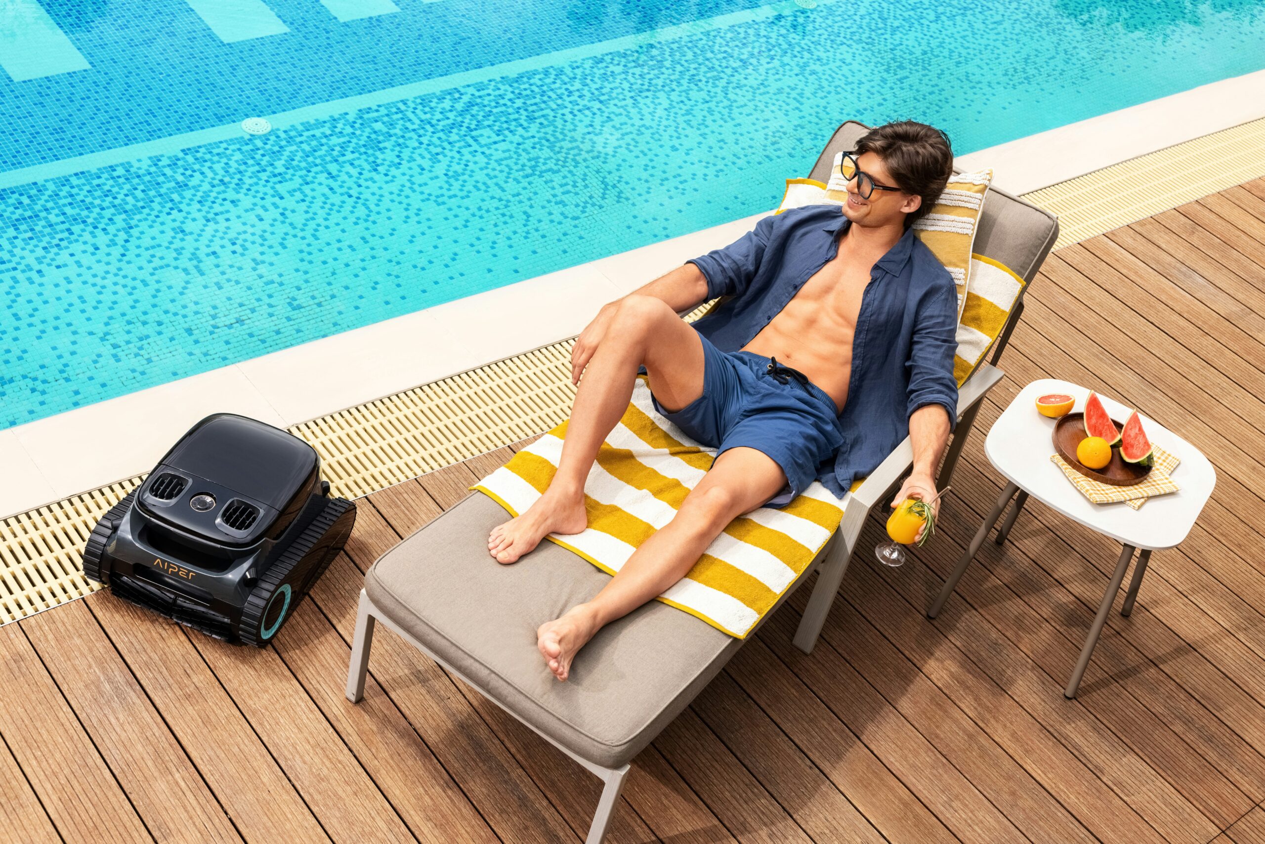 A man laying in a chair next to a pool